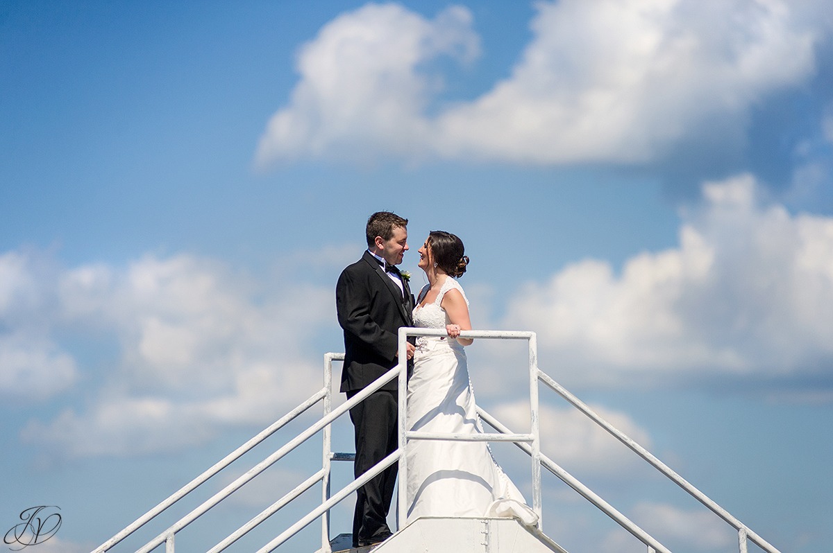 unique photo of bride and groom with sky in background