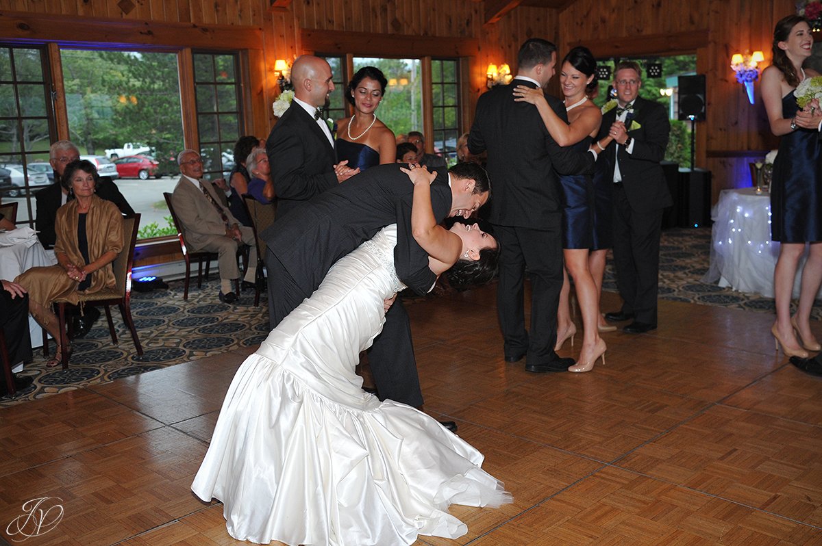groom dips the bride during first dance