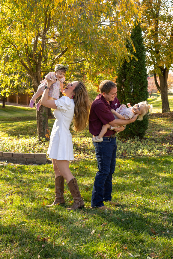 Parents with babies in sunlit park