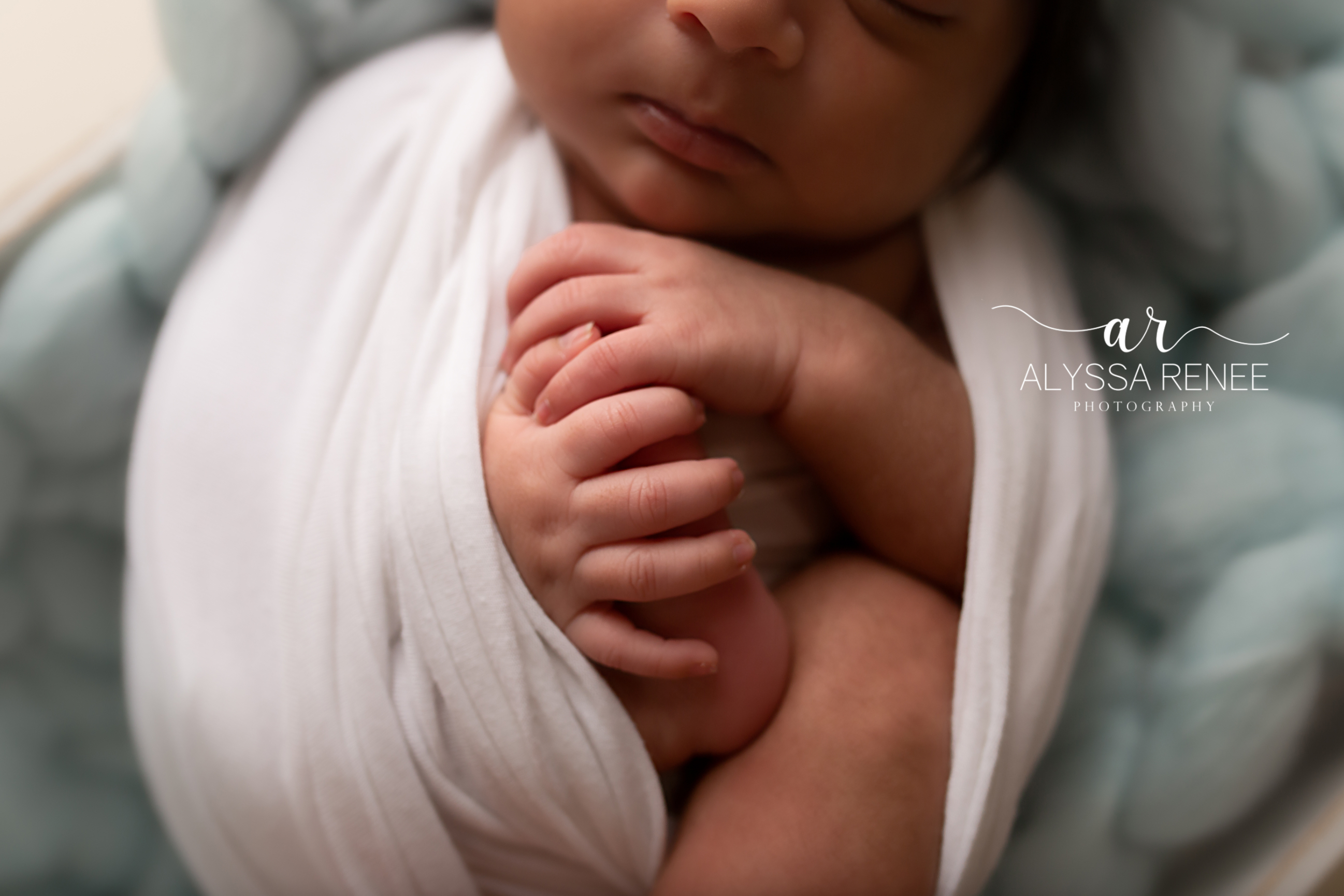 Detail portrait of swaddled baby with handmade blue prop blanket by alyssa Renee Photography
