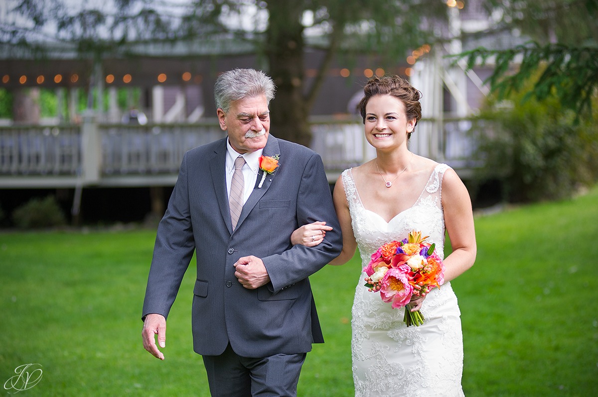 bride walking down aisle with her dad