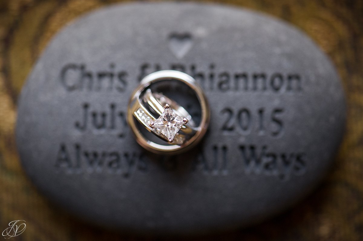 wedding rings on a custom engraved stone