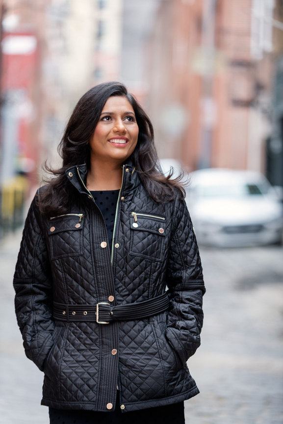 South Asian woman in city street, woman in city street, black jacket, Photography by Heather Raub of FrontRoom Images