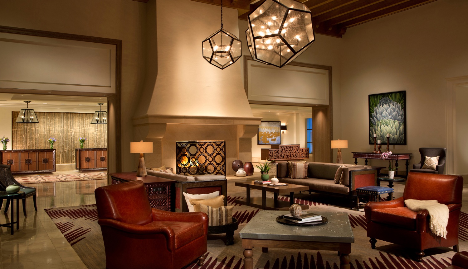 Beautifully decorated Lobby at the La Canterra Resort in Texas with Center Fireplace and front desk in backgrounds.