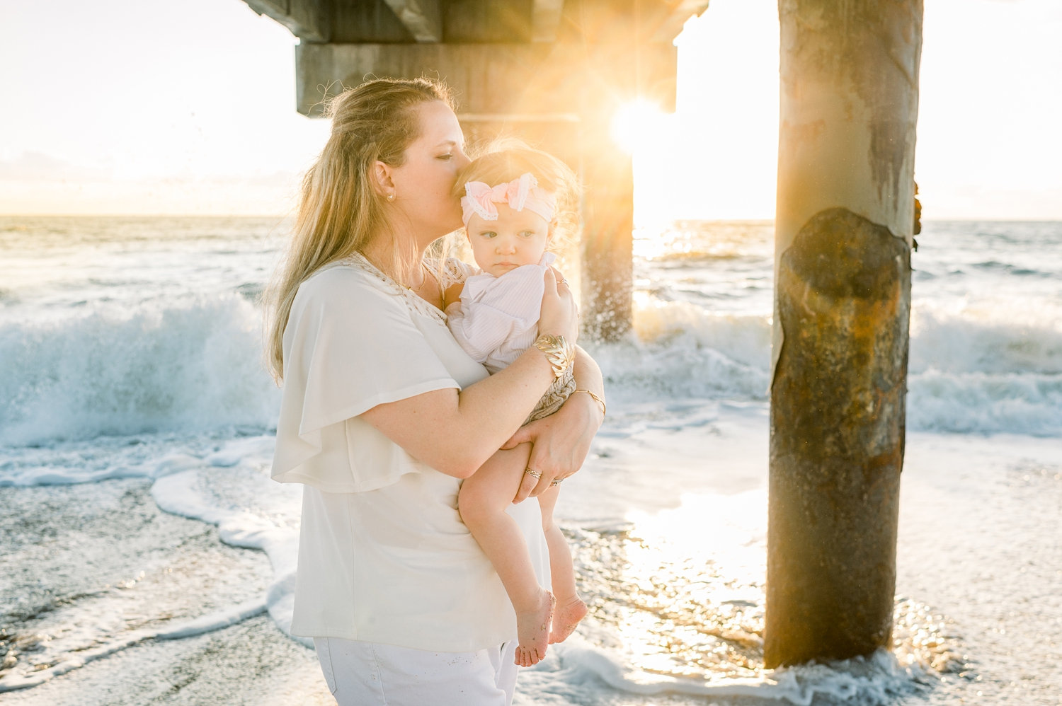 mother kissing baby girl, beach pier, sunrise beach session, Rya Duncklee