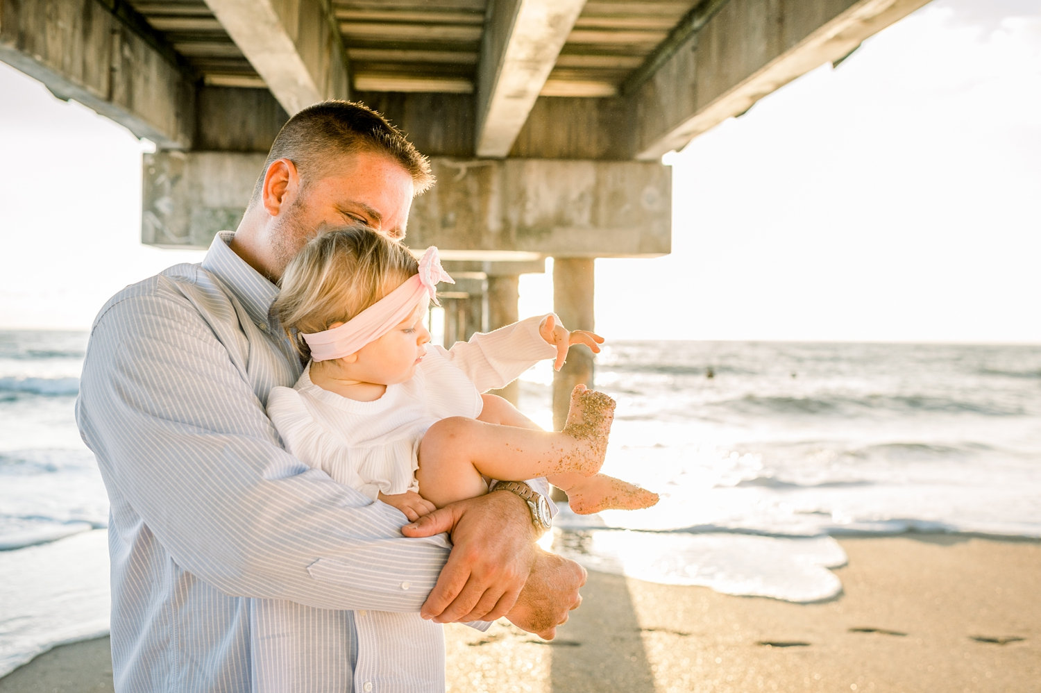 father holding baby daughter, pink wrap headband for baby, sandy baby toes, Ryaphotos