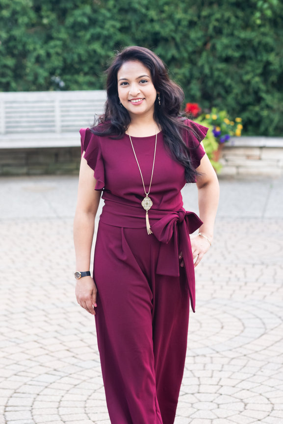 female entrepreneur photographer walks toward camera in local clarkston garden