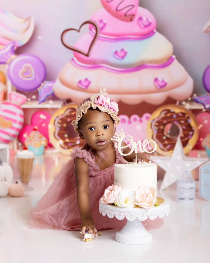 Fun and festive cake smash session - toddler enjoying birthday cake in Orlando, Andrea Ruff