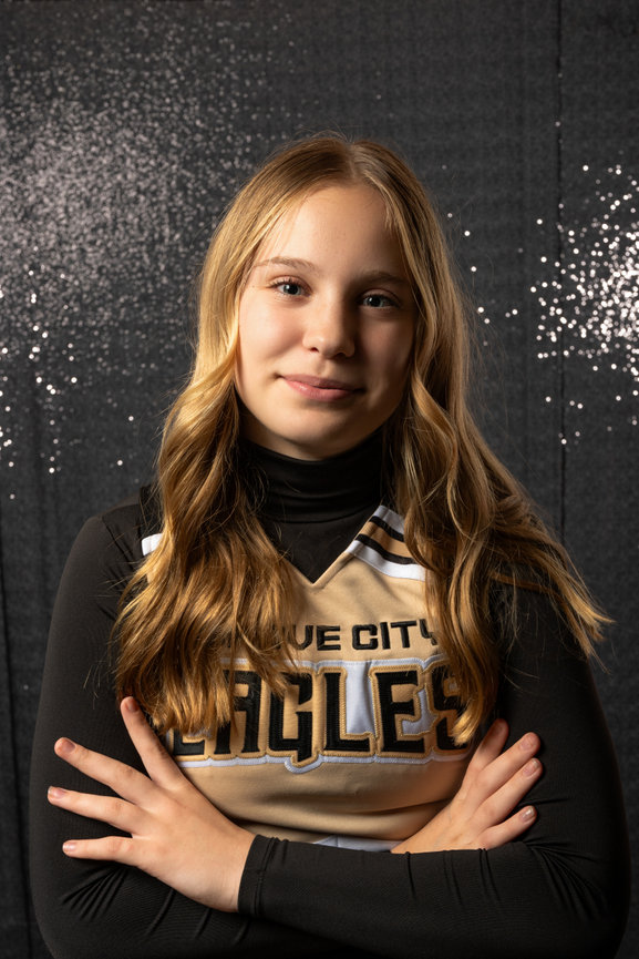 cheerleader headshot in front of a shiny wall