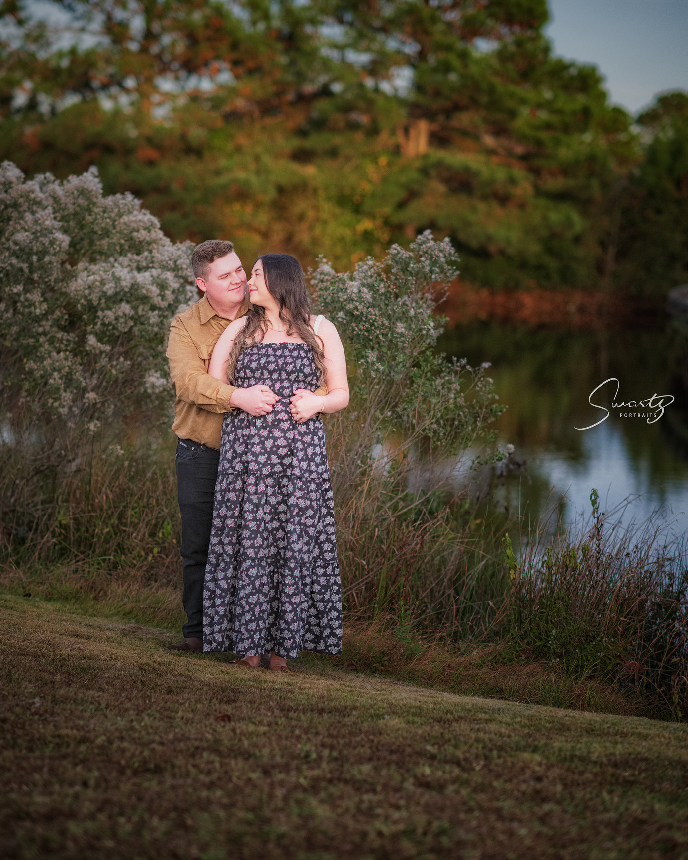 Young Couple standing in front of a Pond