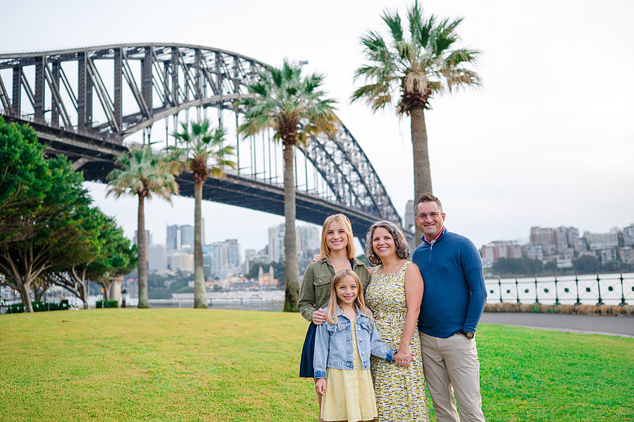 Portrait of a family in a park in front of the Sydney Harbour Bridge during a Sydney Family Photography Session with Sarah Iris Photography.