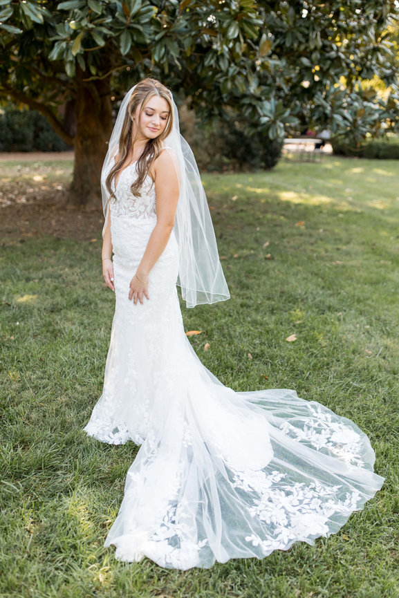 Bride looking over her shoulder at her wedding dress train