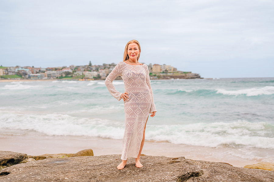 Woman standing near the ocean during a Bondi Beach Solo Vacation Photoshoot.