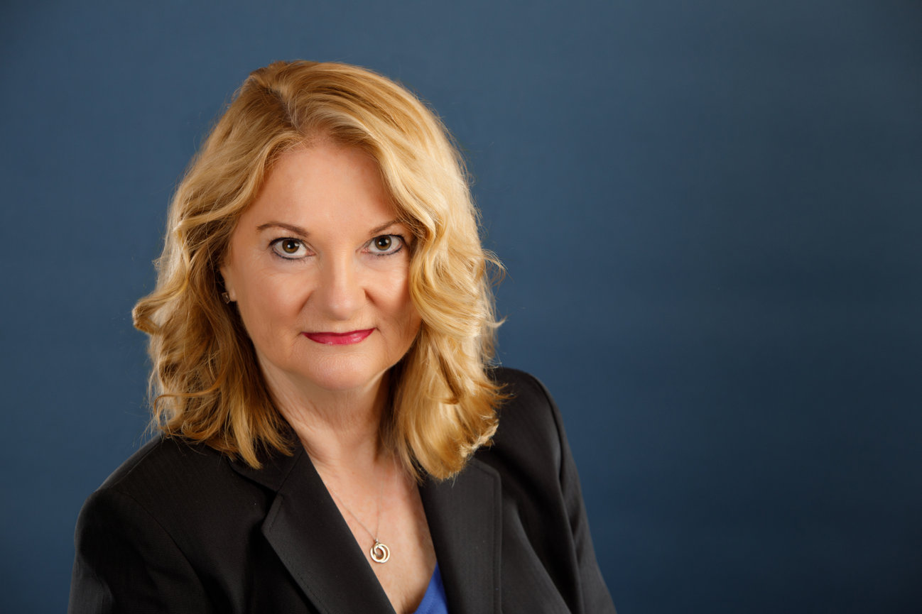 serious executive with black jacket and simple jewelry