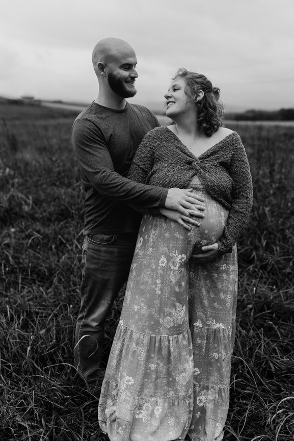 maternity photoshoot in black and white with smiling couple in Huntsville, alabama