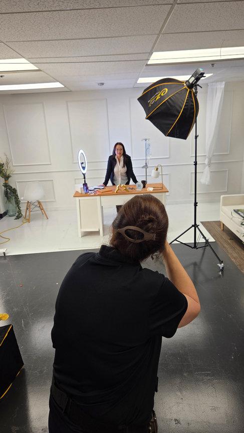 Behind the scenes women's portrait session Orlando - photographer shooting businesswoman at styled desk with ring light and softbox, She's More Than by Karen K Photo