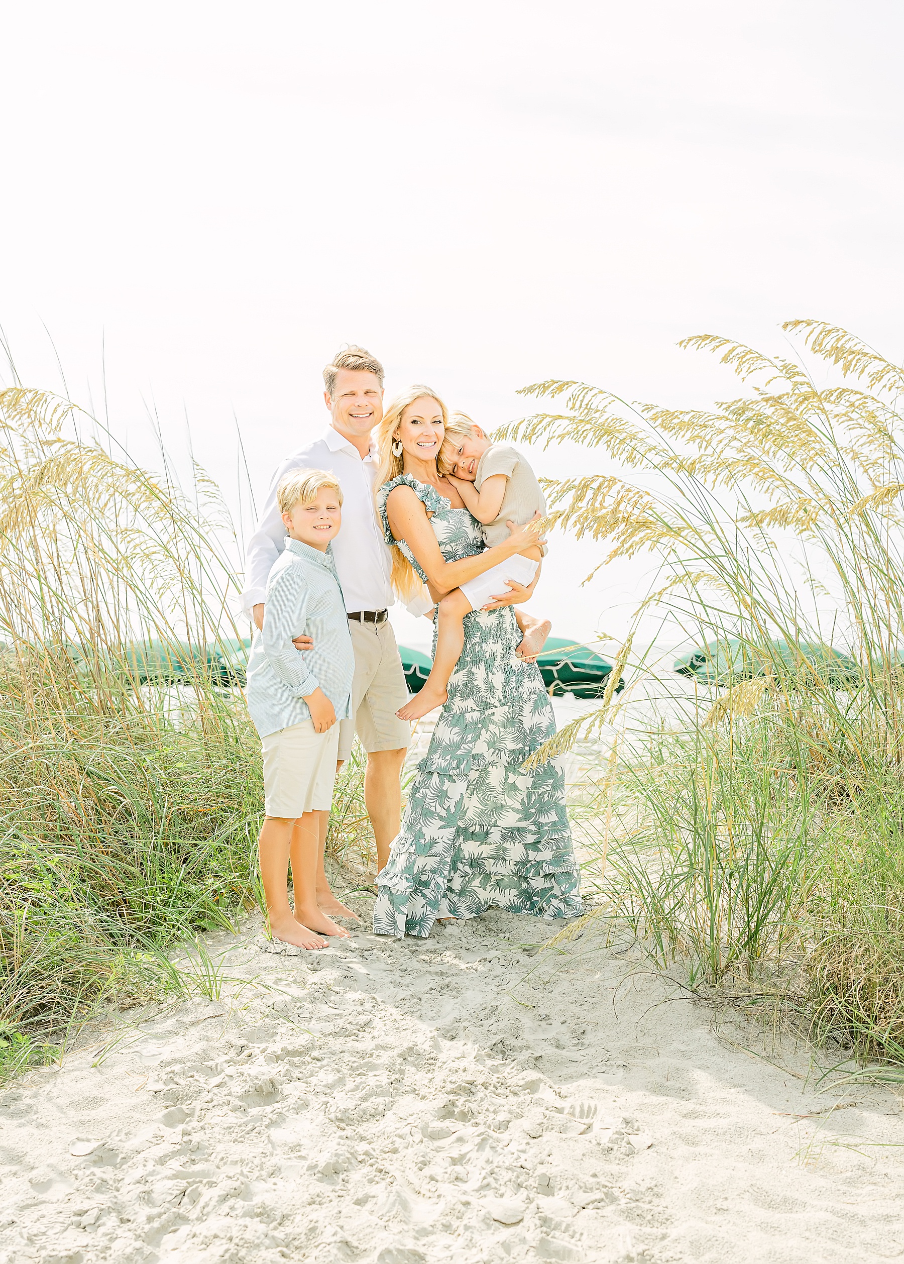 family standing in sea dunes at the beach in georgia