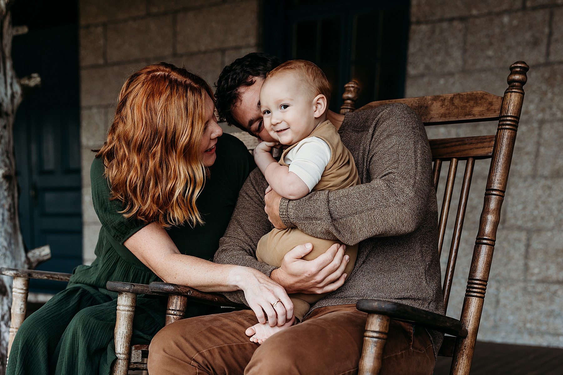 fall family photos with earth toned clothing sitting in a rocking chair