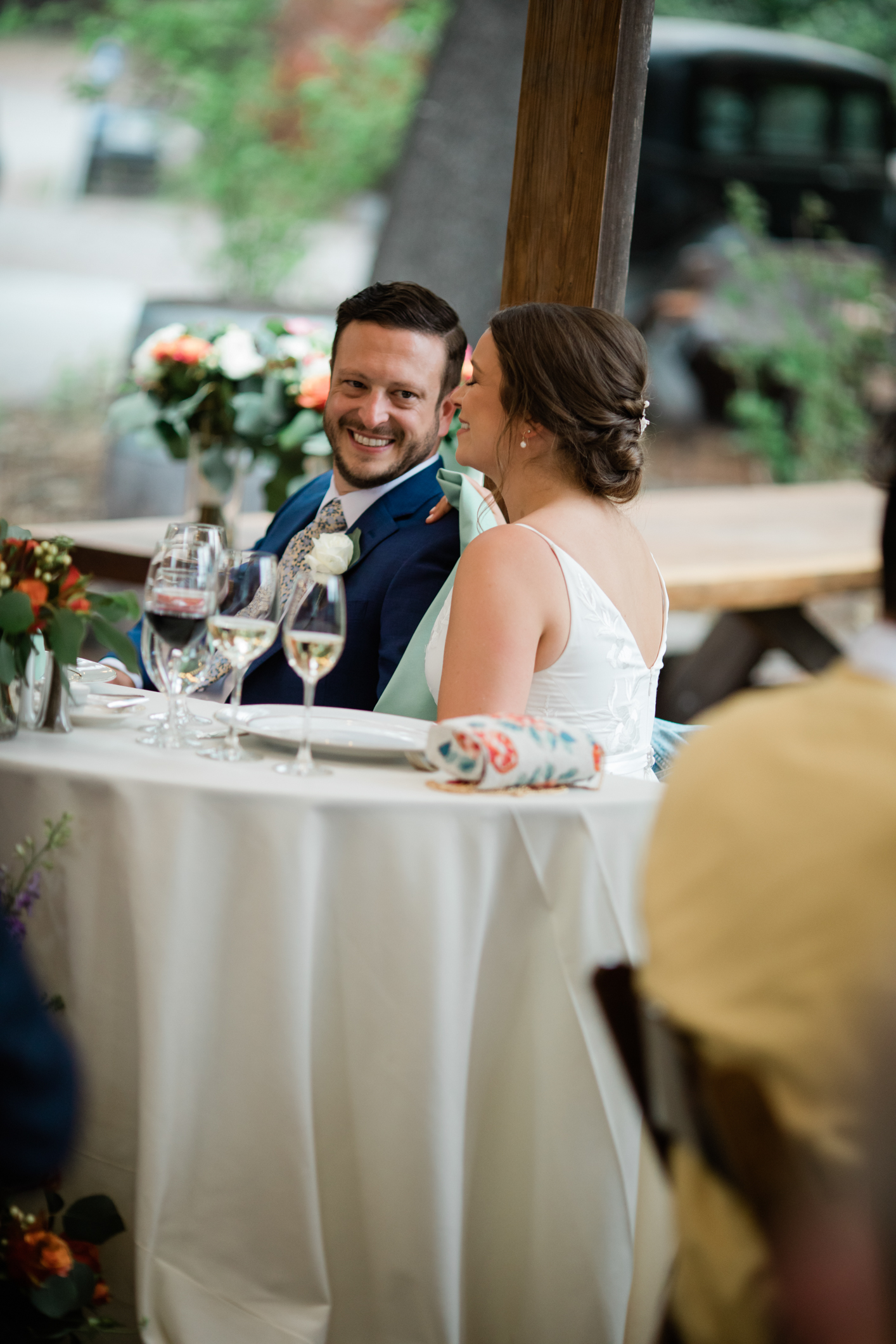 Bride and Groom Laughing at Speeches at Reception