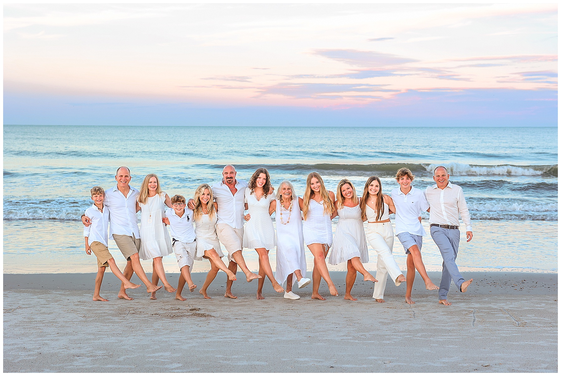 large group of people dressed in white for family photos at the beach in Amelia Island Florida