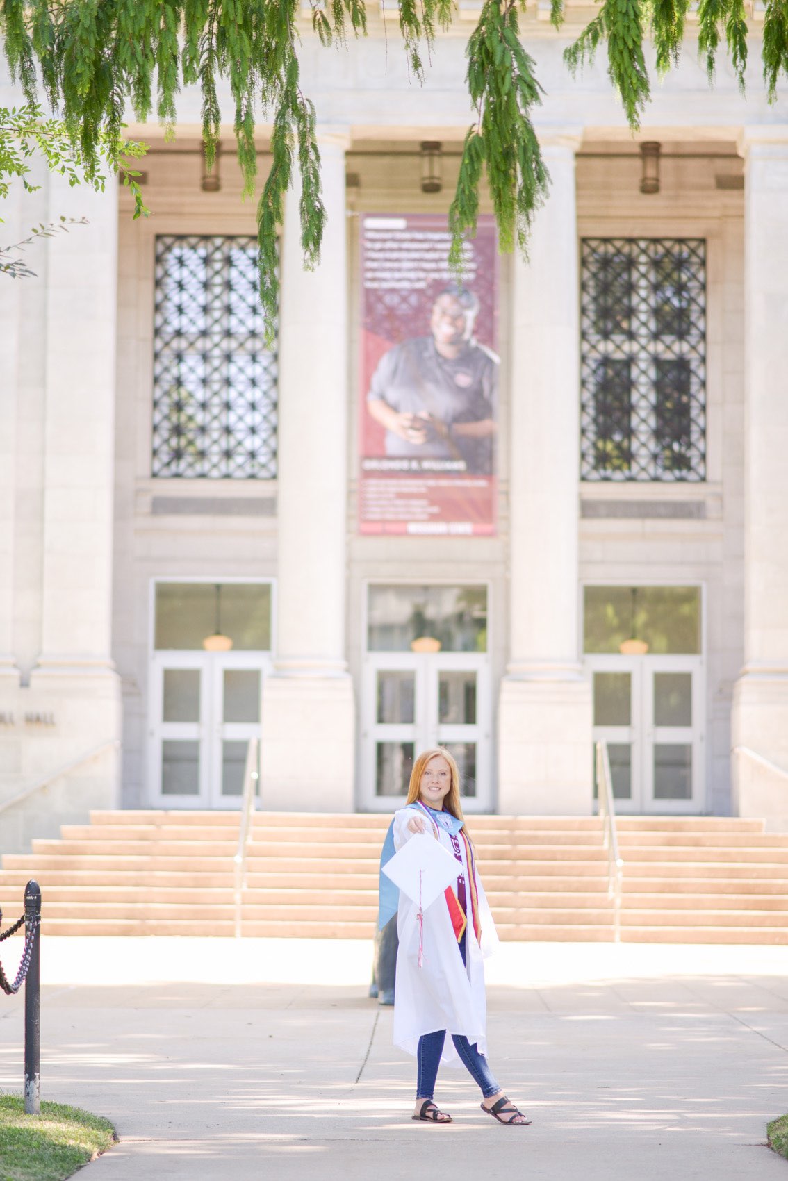 Senior girl wearing Missouri State University tshirt and wearing graduation robe.