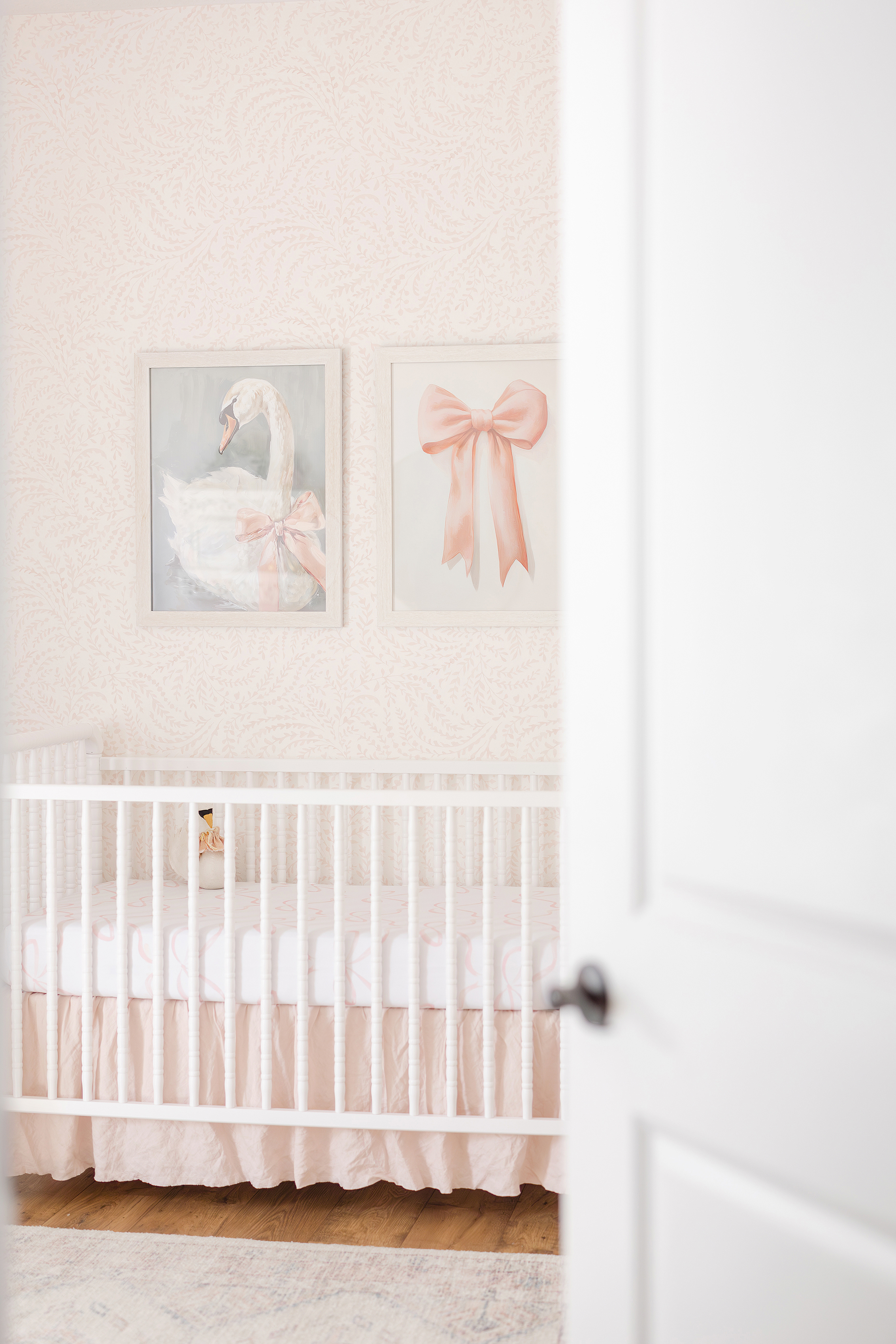 A baby girl's nursery detail shot with pink and white details.