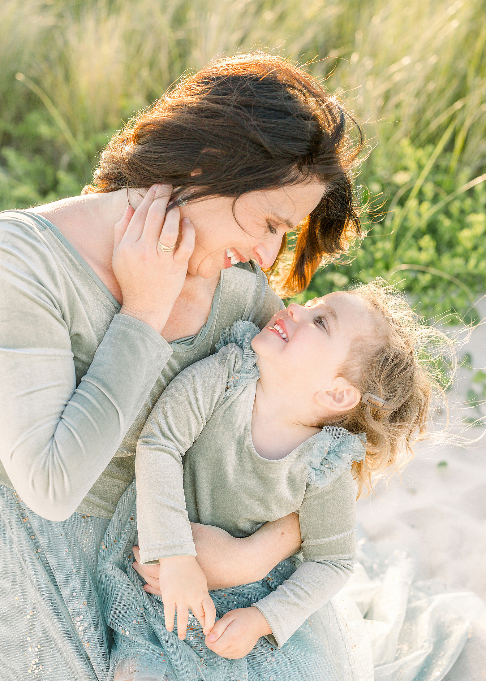 A light and airy mother and daughter beach portrait.