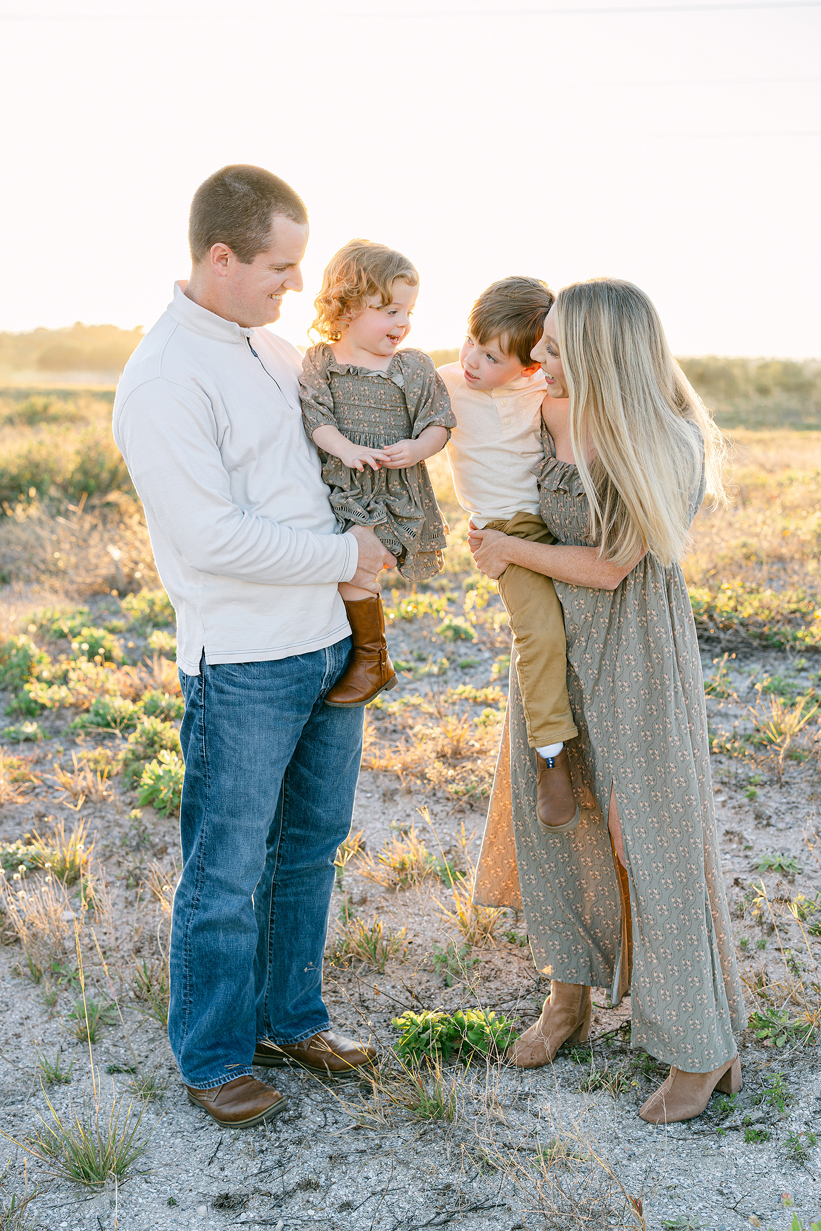 Candid family portrait of a family of four in St. Augustine Beach.