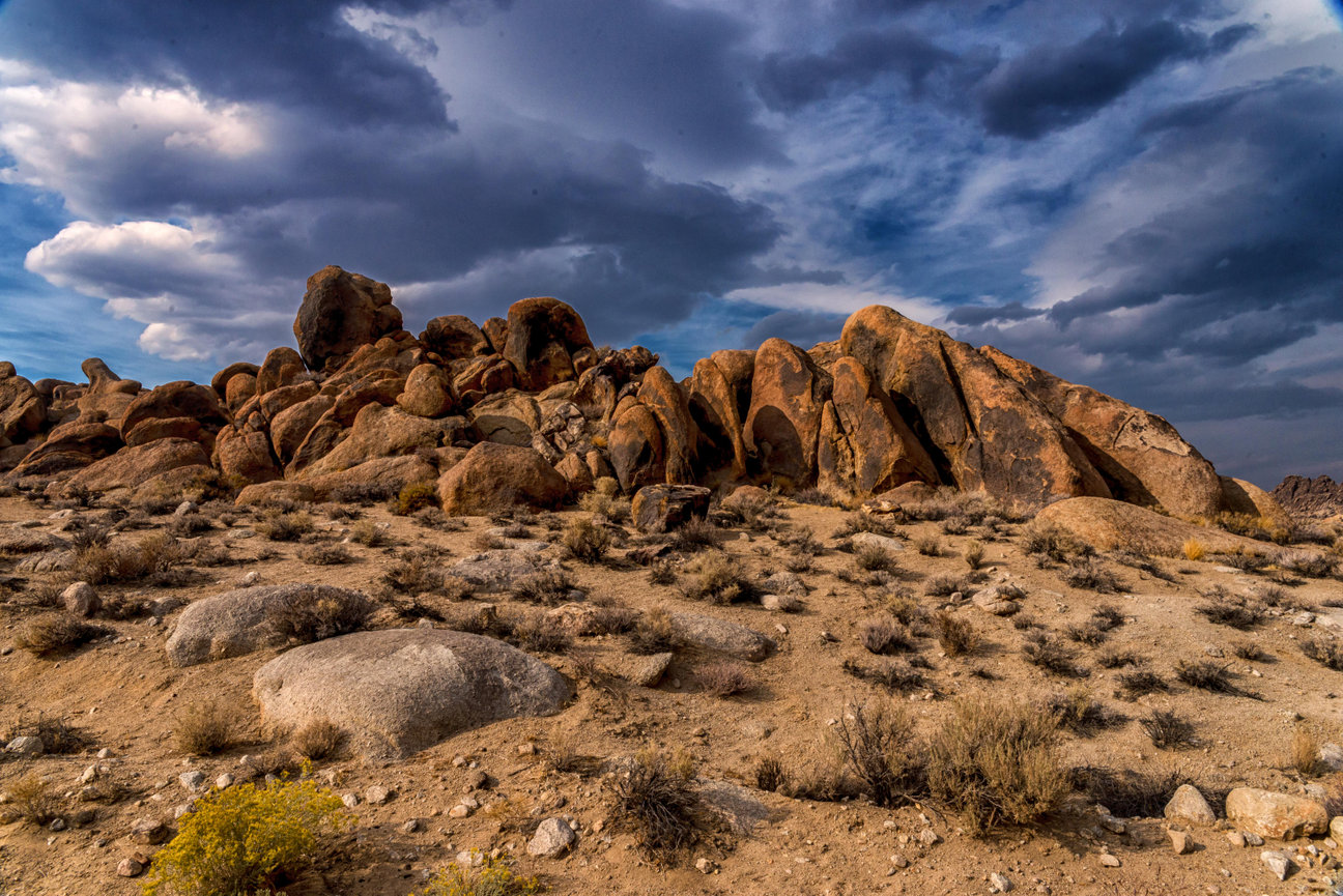 Desert rock formation under dramatic storm clouds