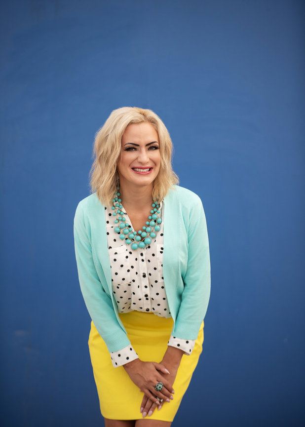 Bold and beautiful branding with happy smiling blonde entrepreneur in yellow skirt against blue wall, by San Diego Brand Photographer, Stefanie Blue.
