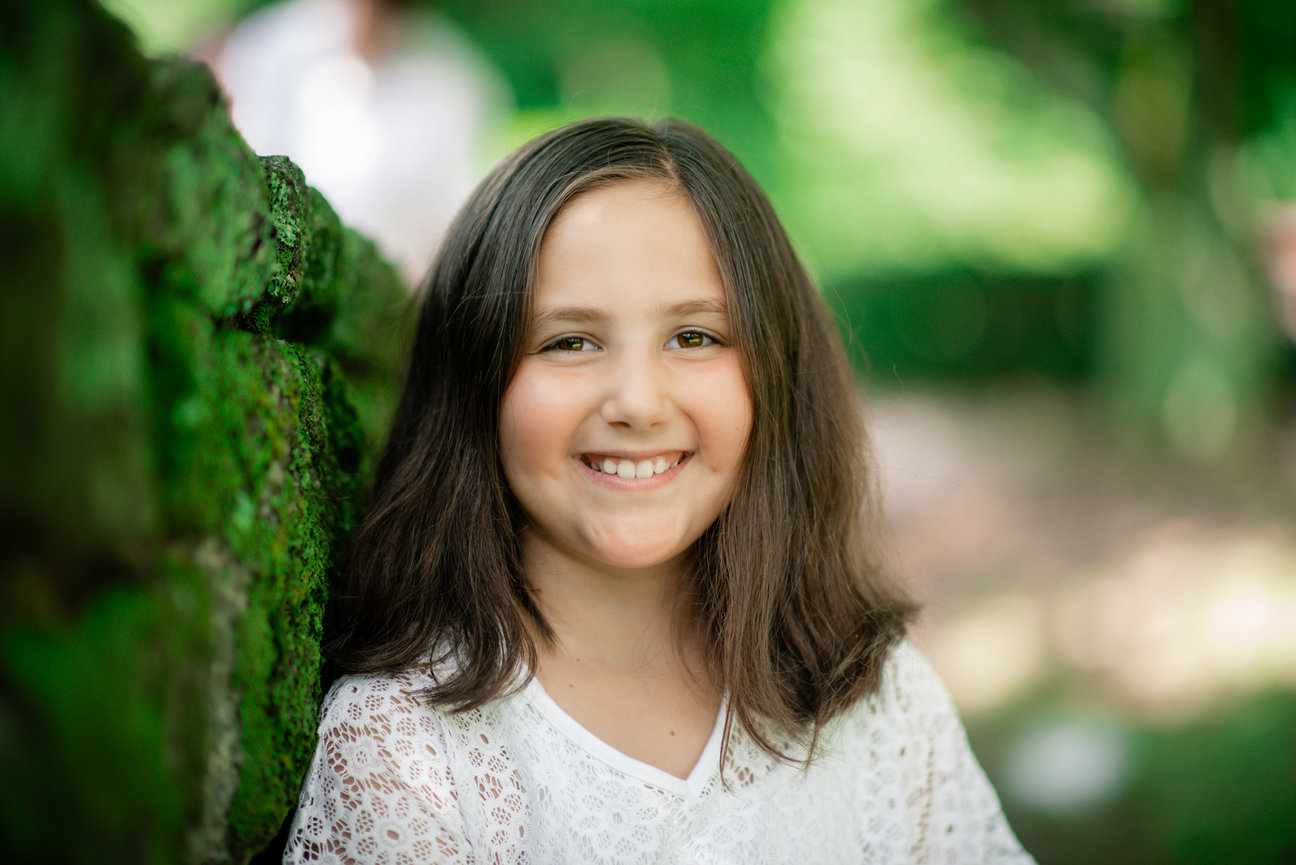 Young girl smiling in a garden