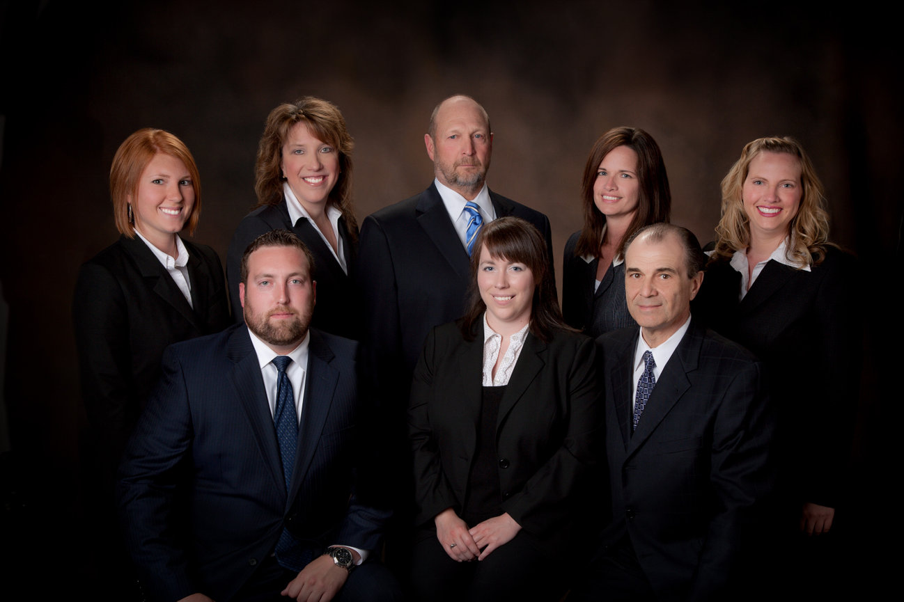 A group business portrait of eight lawyers and staff.