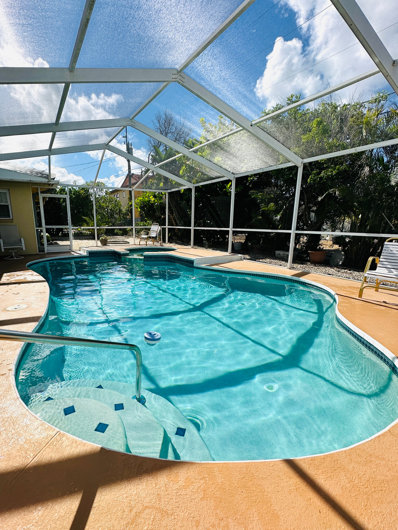 Clean screened swimming pool maintained by Playa Pool Pros
