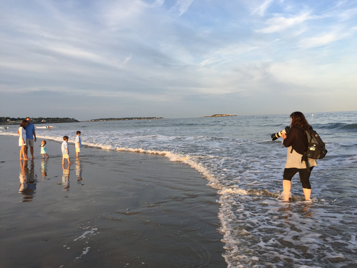 Paula Swift photographing a family on a norht shore ma beach at sunset.
