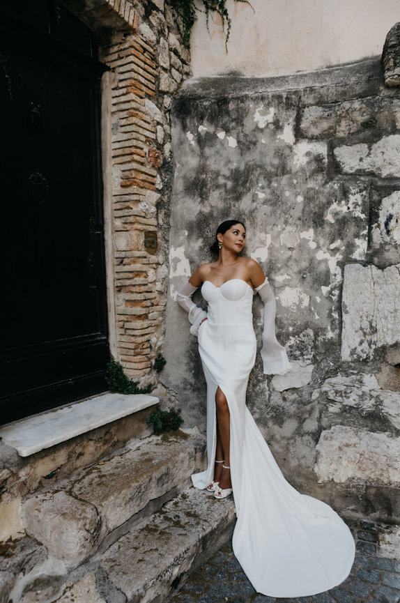 High-fashion bridal portrait on the French Riviera; a bride in a strapless dress and opera gloves with a refined editorial edge.