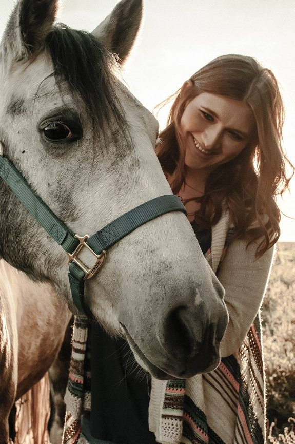 high school senior girl with a white horse