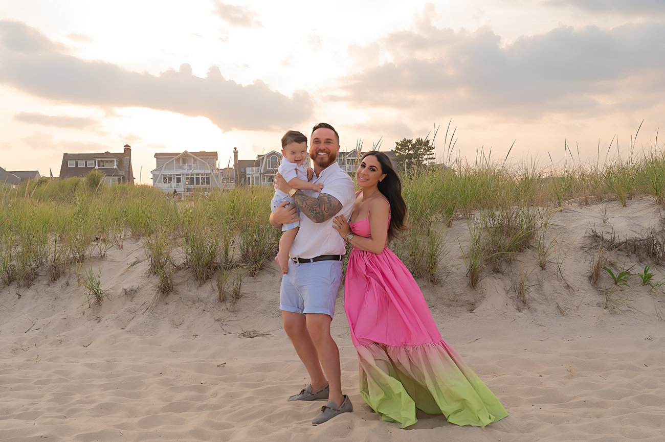 Perfectly posed family smiling along the dunes in Spring Lake beach