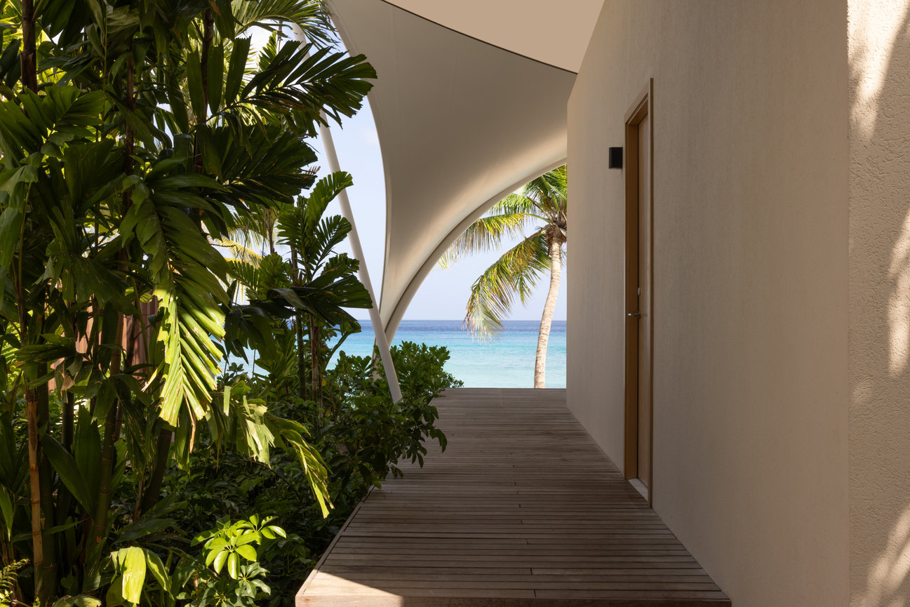 Beautiful lush plant filled Guest room Entrance on the ocean at Silversands Beach House in Grenada.