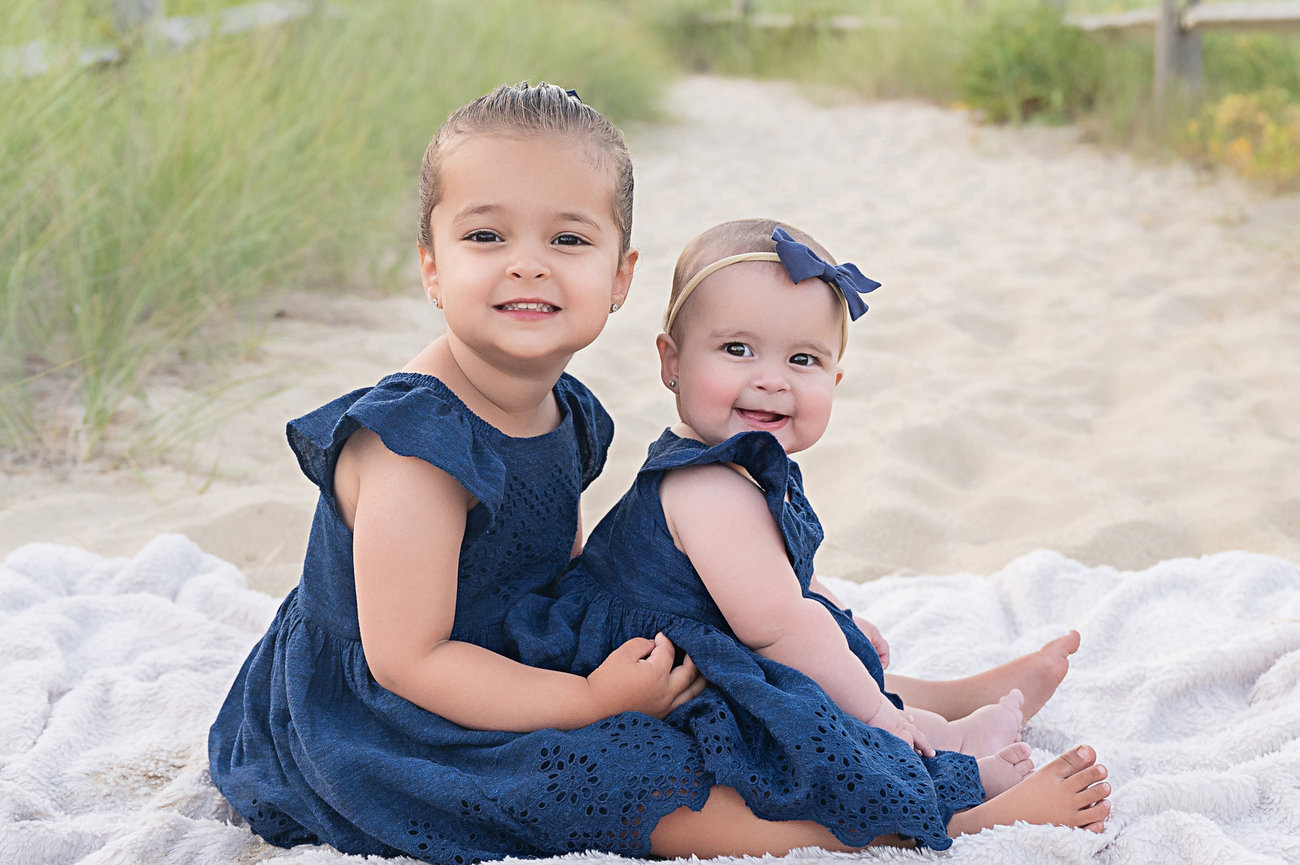 Toddler and baby on a blanket during a sunset beach session