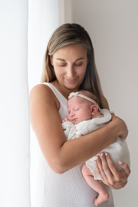 Tender moment between mom and baby captured during lifestyle session in Monmouth County