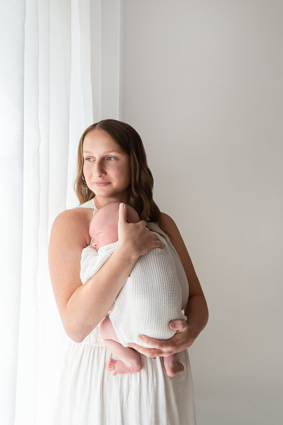 Baby resting on parent’s chest in Kristin Baker Photography’s Manasquan studio