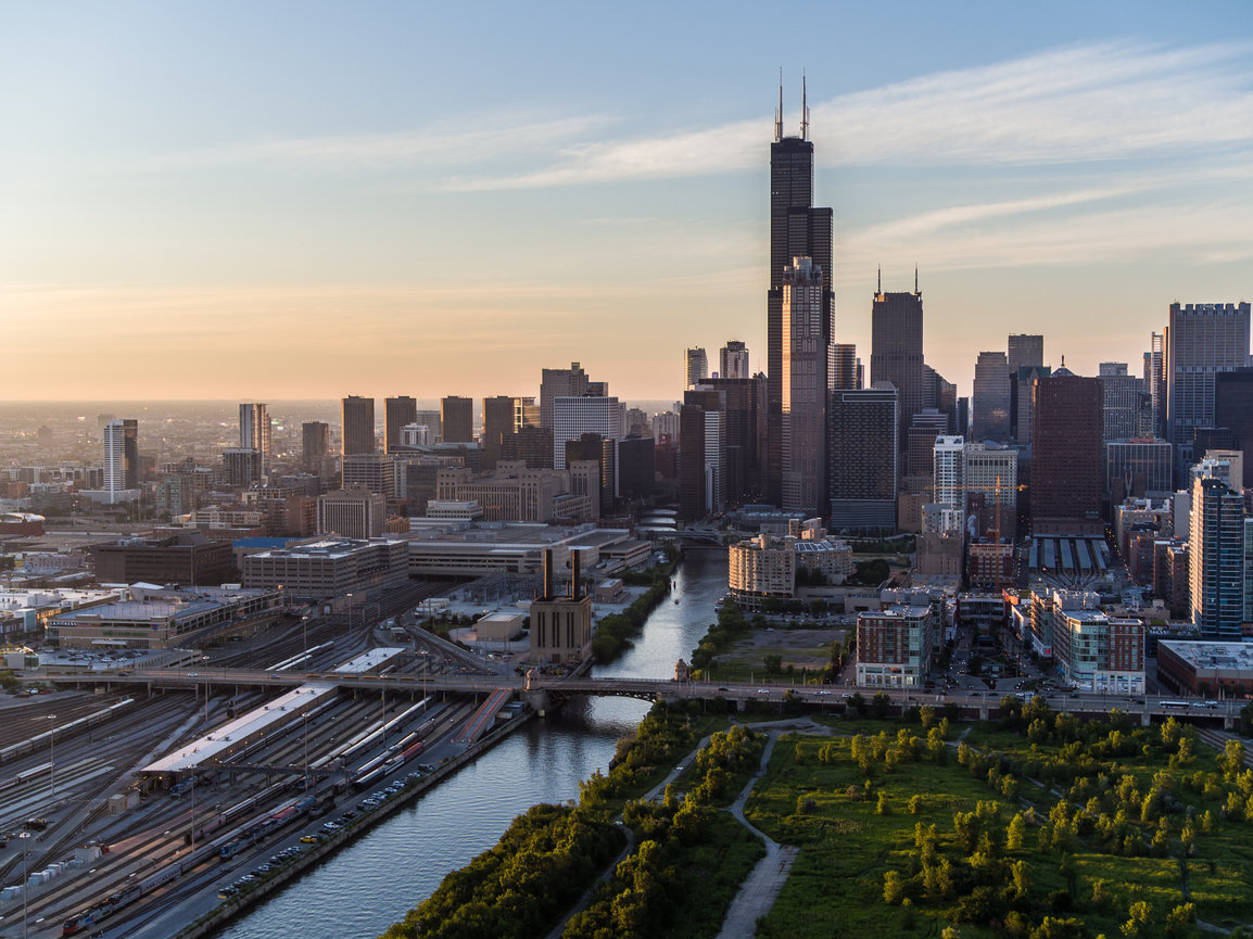 City buildings at sunset with park view