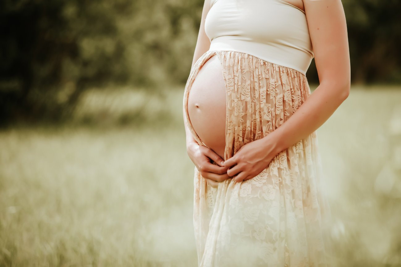 baby bump maternity photo in prairie grass field