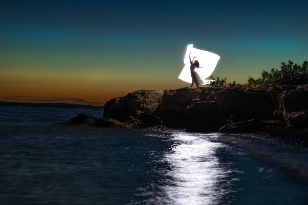 Light painting portrait on ocean cliffs at night, glowing ribbon effect over water, Fort Worth Texas creative portraits
