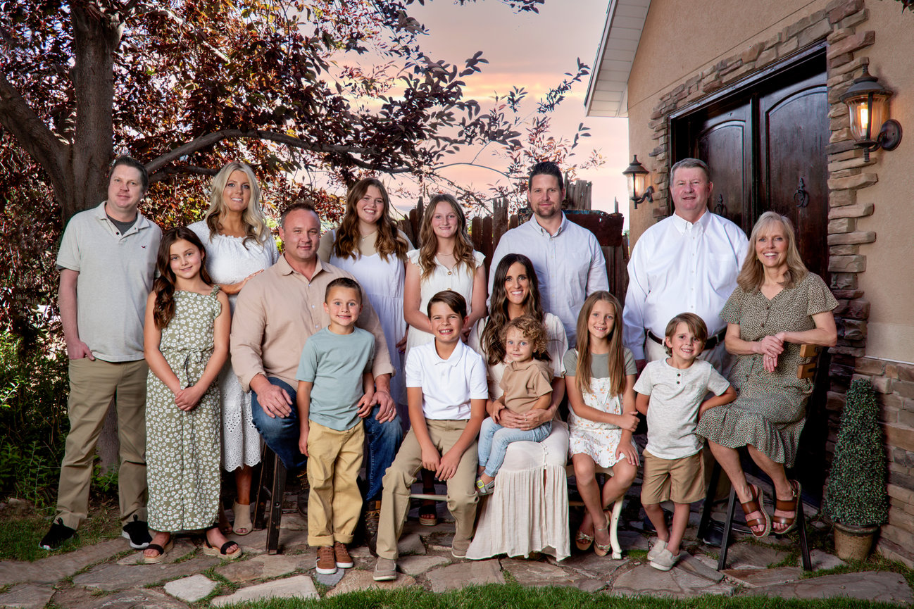 A family posing in front of a building with a large wooden door.