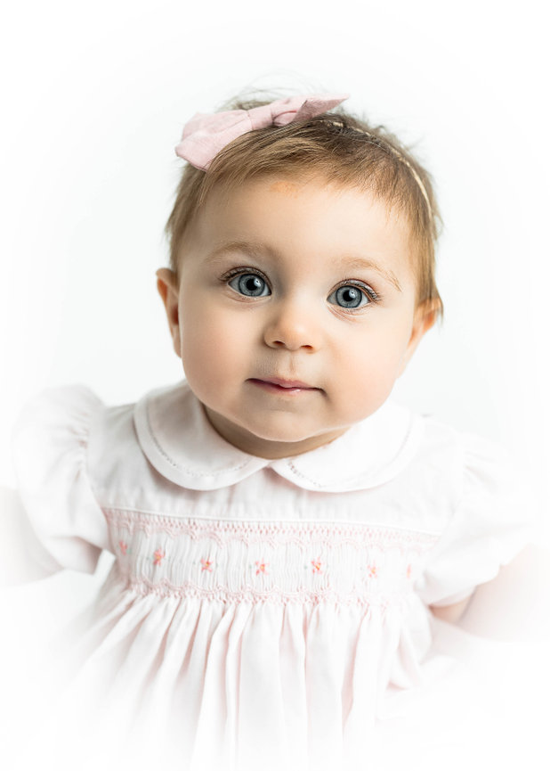 Fine art heirloom portrait of baby with delicate lace headband and dress