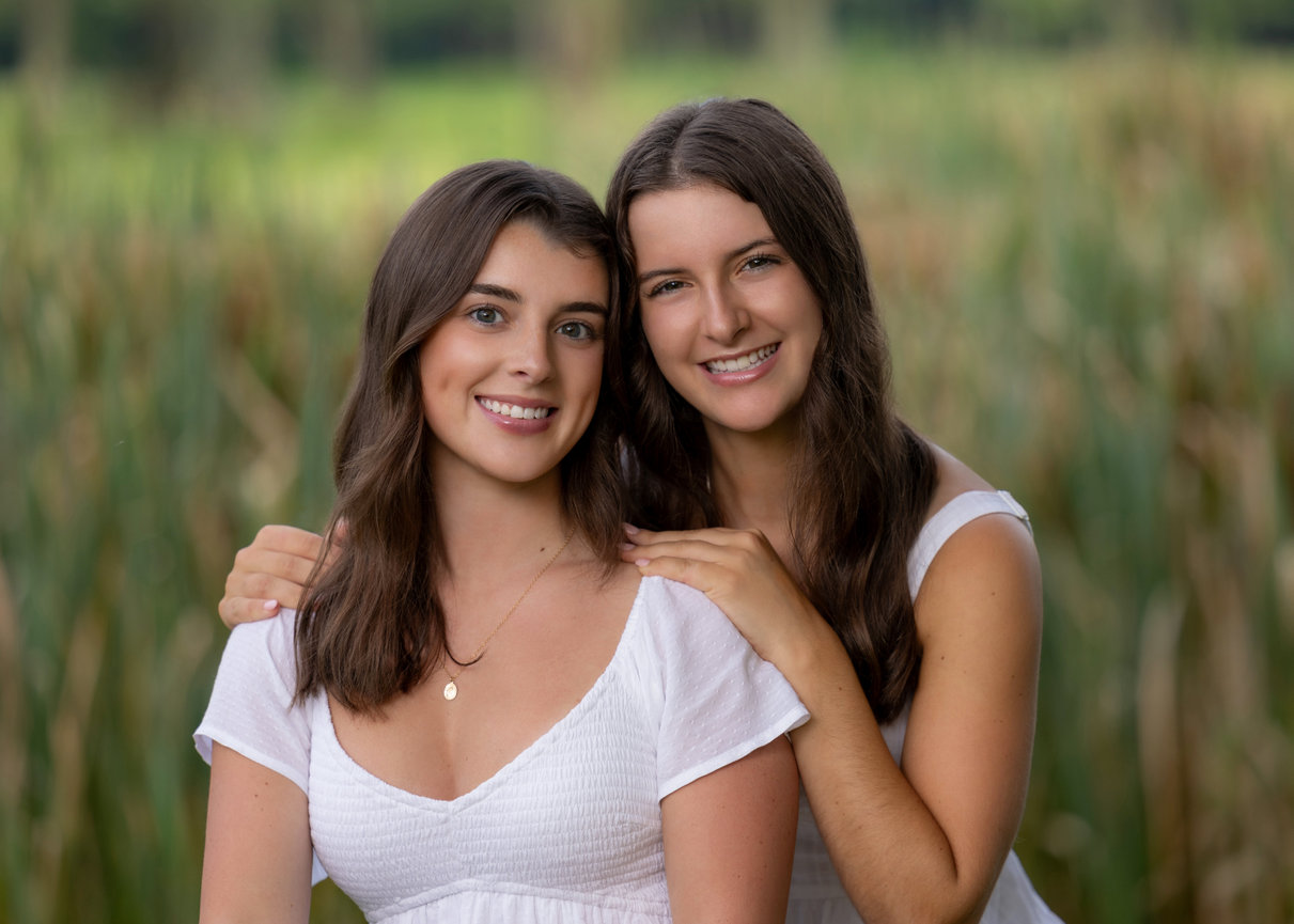 Outdoor portrait of two sisters with reeds in background at golf course sharon ma