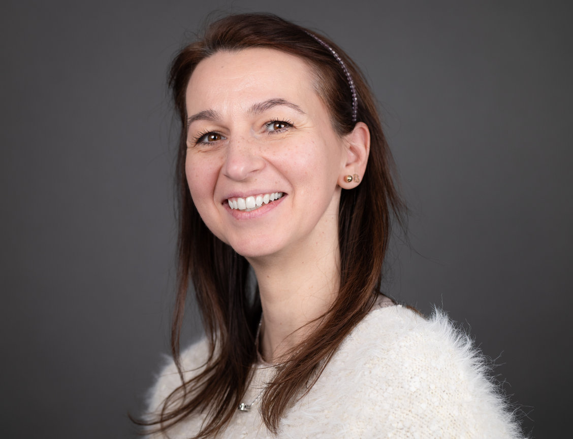 Woman smiling with gray background