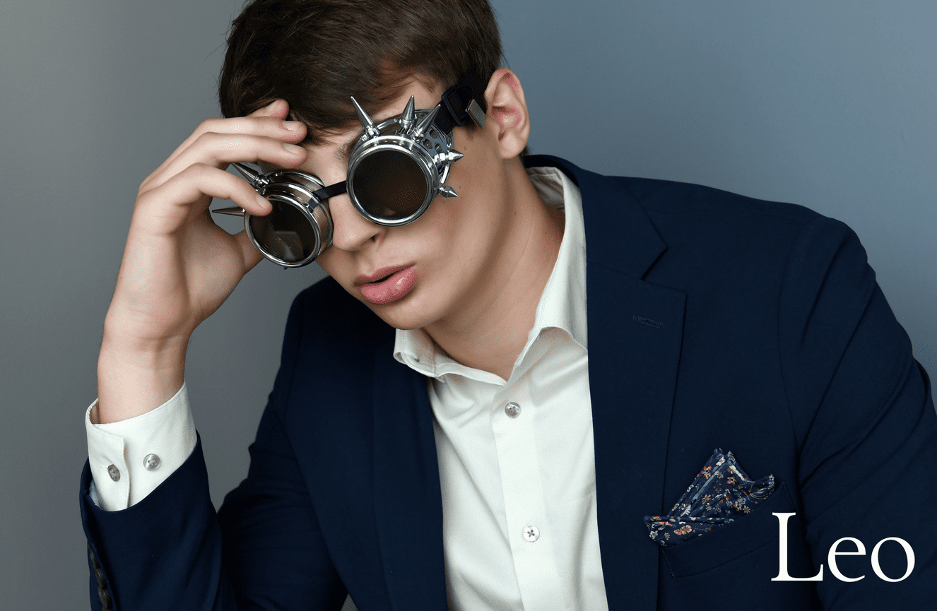 Leo wearing spiky sunglasses during his high school photo session at Kliks Photography.