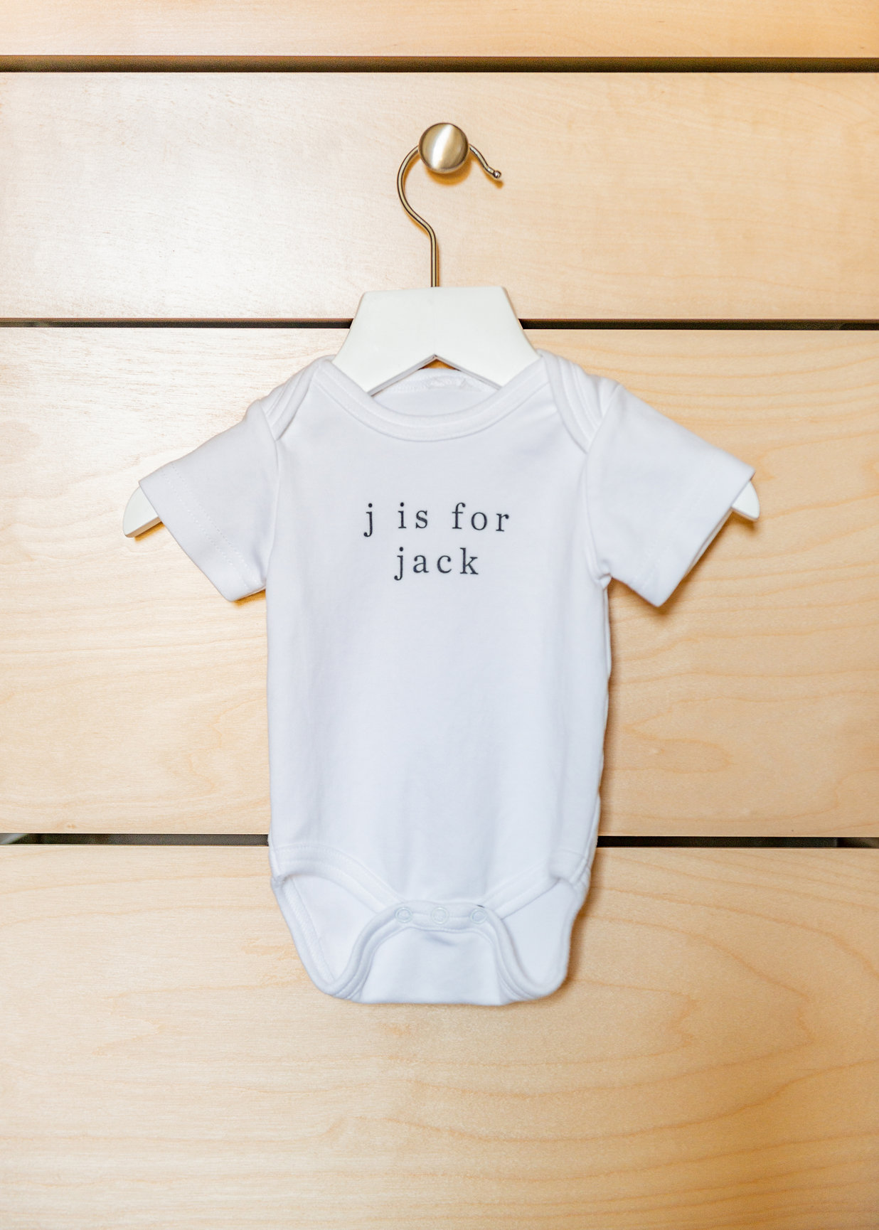 j is for jack onesie, blonde wood drawers, cream colored baby hanger